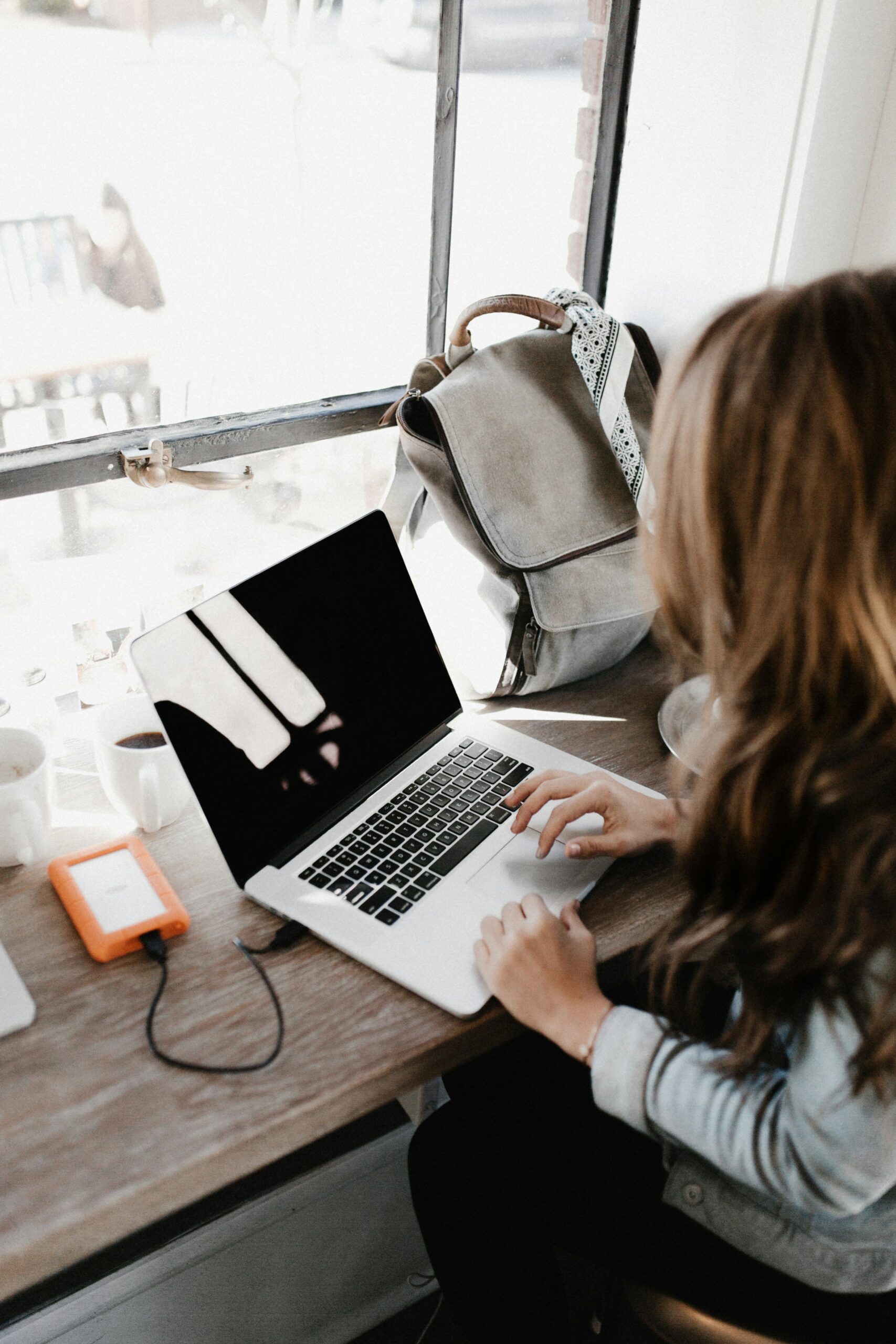 A female photographer on her computer working on her photography website